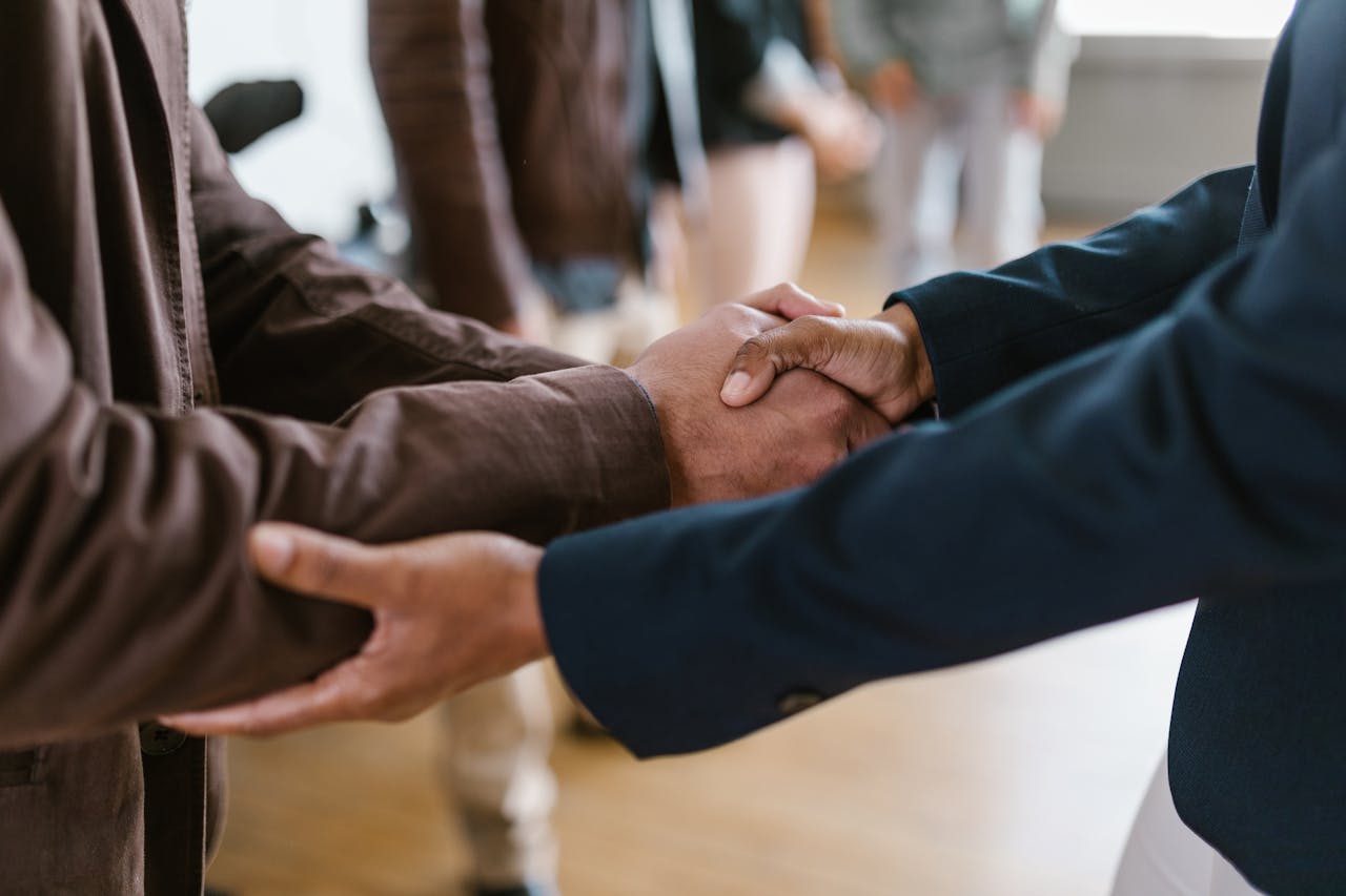 Business partners shaking hands to confirm an agreement
